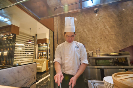 SINGAPORE - CIRCA JANUARY, 2020: man cooking fried eggs at Mercure Singapore Bugisのeditorial素材