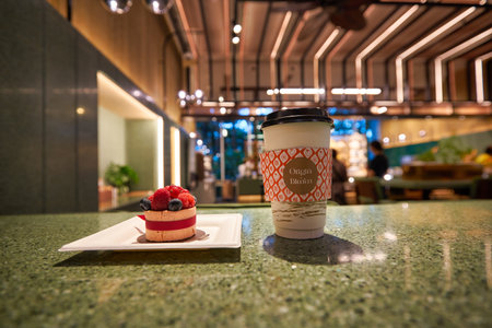 SINGAPORE - JANUARY 20, 2020: dessert and cup of coffee served on a table in Origin + Bloom at Lobby Marina Bay Sands.のeditorial素材