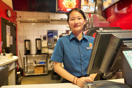 SHENZHEN, CHINA - CIRCA NOVEMBER, 2019: portrait of worker at McDonald's Dessert Kiosk in Shenzhen.のeditorial素材