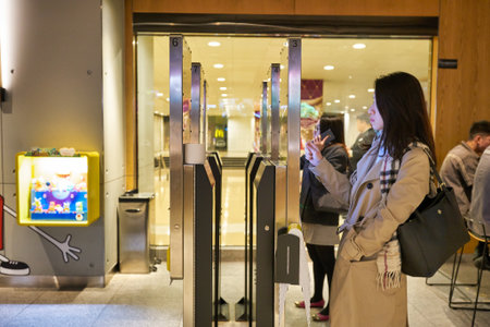 HONG KONG, CHINA - CIRCA DECEMBER, 2019: woman use self-ordering kiosk at McDonald's restaurant in Hong Kong. McDonald's is best known for its hamburgers, cheeseburgers and french fries.のeditorial素材
