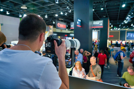 COLOGNE, GERMANY - CIRCA SEPTEMBER, 2018: man try Canon cameras at the Photokina Exhibition....