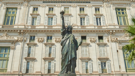 NICE, FRANCE - AUGUST 15, 2015: close up shot of replica of the Statue of Liberty with southern facade of the Opera de Nice in the background in Nice.のeditorial素材