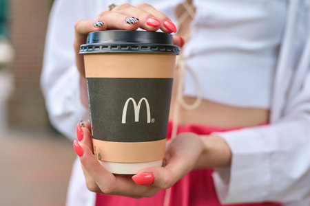 KALININGRAD, RUSSIA - CIRCA JULY, 2022: close up shot of the Golden Arches sign as seen on the paper cup from McDonald's restaurant, closed after sanctions were imposed.のeditorial素材