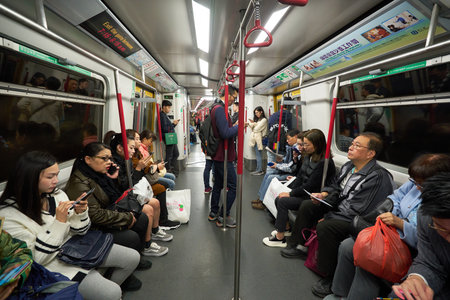 HONG KONG - CIRCA DECEMBER, 2019: commuters inside a MTR train in Hong Hong. The Mass Transit Railway (MTR) is a major public transport network serving Hong Kong.のeditorial素材