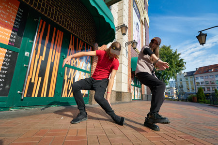 KALININGRAD, RUSSIA - CIRCA SEPTEMBER, 2022: teenagers dance against the background of McDonald's...