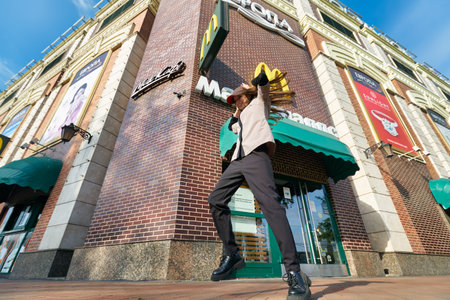 KALININGRAD, RUSSIA - CIRCA SEPTEMBER, 2022: teenager dance against the background of McDonald's...