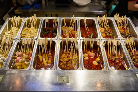 SHENZHEN, CHINA - CIRCA NOVEMBER, 2019: various food on sticks on display at Deli City at MixC shopping mall in Shenzhen.のeditorial素材