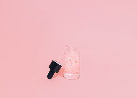 Facial gel Photo in minimal style with copy space Liquid gel in glass bottle with pipette on pink backgroundの写真素材