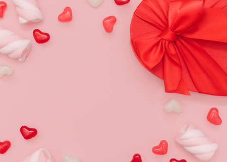 romantic gift. Top view photo with copy space. Colorful sweet food and desserts with gift box in heart shapeの写真素材