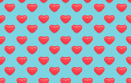 Valentine's day seamless pattern in pop art. Bright texture with red glazed candies on a turquoise backdropの写真素材