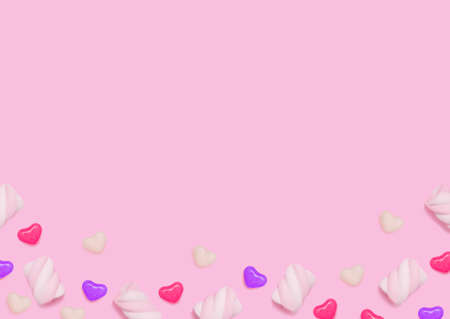 Lollipops and bonbons. Template with copy space. Swirl marshmallows and heart shaped candies on pink backdropの写真素材