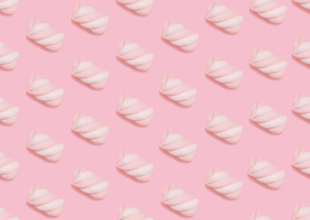 Marshmallow. Seamless pattern. Swirl two-tone puff candies on pastel pink backdropの写真素材