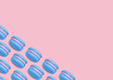 Almond cookies. Top view photo with copy space. Bright blue macaroons on pink background. Minimal styleの写真素材
