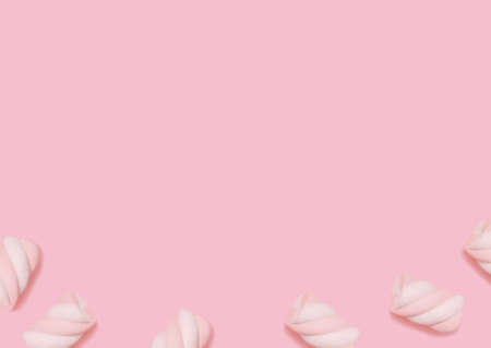 Marshmallow. top view photo. Striped two-tone bonbons on pastel pink background