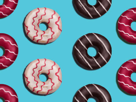 donuts. Flat lay photo pattern. Various colorful glazed donuts on blue backdrop