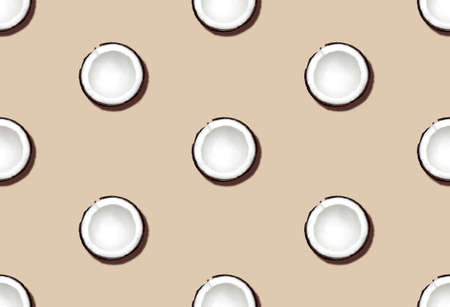 Halved coconuts. Seamless pattern. Fresh cut coconuts on beige background. top view.