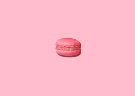 Macaron. Photo in minimal style. French almond cookie on pastel pink backgroundの写真素材