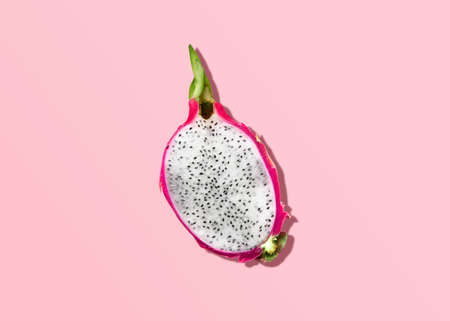 dragon fruit. flat lay photo. Half of pitaya on pink backdrop. Minimal styleの写真素材