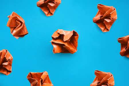 Brainstorm. top view photo. Crumpled orange paper on bright blue backdropの写真素材