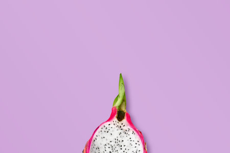 Banner template with dragon fruit and copy space. Half of juicy delicious pitahaya on purple background. Minimal styleの写真素材