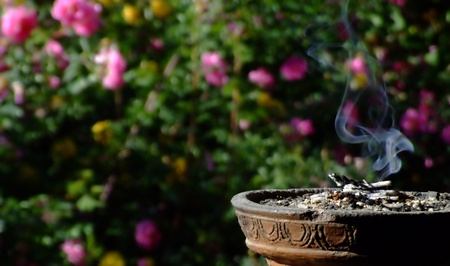 Smoking incense with floral backgroundの写真素材
