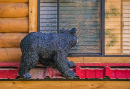 Carving of a curious  black bear on a cabin in Jackson, Wyoming.のeditorial素材