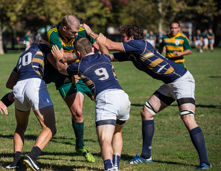 A Humboldt player green  gets tackled by  UC Davis  at a rugby tournament in Redding, California. Photo taken on: November 08th, 2014のeditorial素材