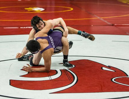 Photo taken  03/06/2016 :   Two wrestlers on the mat against each other in the NCSIF Wrestling Championships in northern California.のeditorial素材