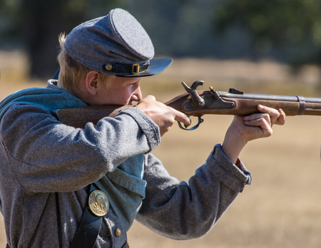 Confederate in combat at the Hawes Farm Reenactment in Anderson, California.のeditorial素材