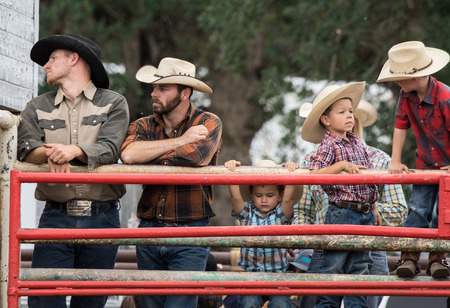 Cowboys watching the Cottonwood Rodeo in Cottonwood, California.のeditorial素材