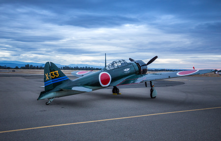 A Japanese Zero belonging to the Commemorative Air Force sits on the runway at dawn during the Redding Airshow.のeditorial素材