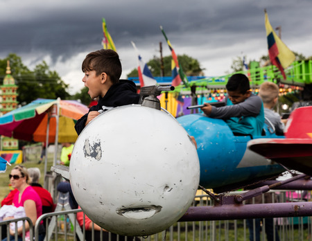 Kids enjoying a ride at the Shasta County Fair in Anderson, California.のeditorial素材