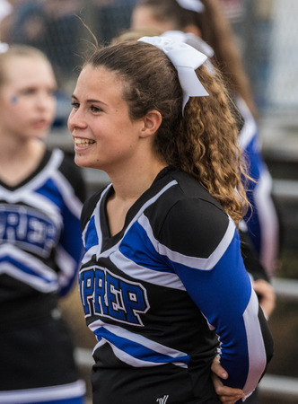 Cheerleader at a high school football game in Redding, California.のeditorial素材
