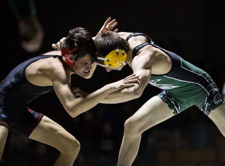 Wrestling action with Red Bluff vs. Foothill High School under the spotlight in Palo Cedro, California.のeditorial素材