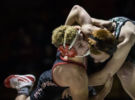 Wrestling action with Red Bluff vs. Foothill High School under the spotlight in Palo Cedro, California.のeditorial素材