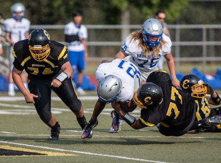 Football action with McQueen High School vs. Enterprise in Redding, California.のeditorial素材