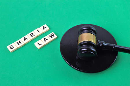 Selective focus of judge gavel and letters with text SHARIA LAW.