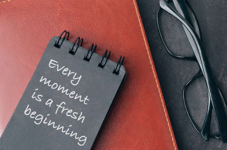 Notebook written with quote EVERY MOMENT IS A FRESH BEGINNINGの写真素材