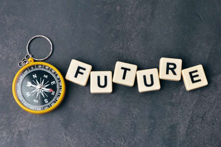 Top view of magnetic compass and square letters with text FUTURE.の写真素材