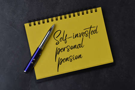 Notebook written with text SELF INVESTED PERSONAL PENSION.の写真素材