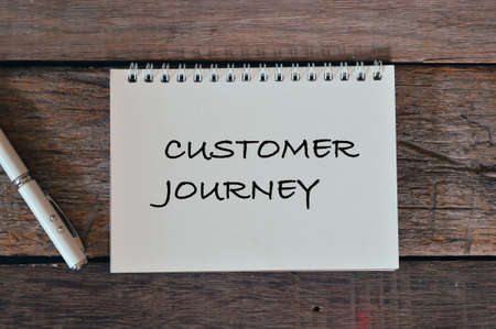 Selective focus of notebook written with text CUSTOMER JOURNEY.の写真素材