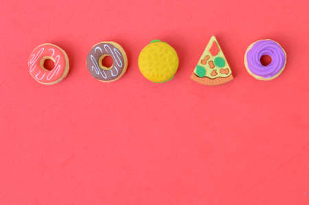 Rubber food toys over red background.