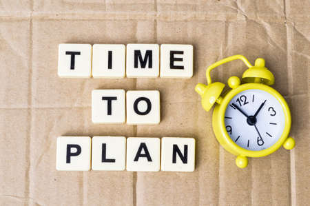 Top view of clock and square letters with text TIME TO PLAN.の写真素材