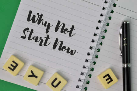 Top view of notebook written with question WHY NOT START NOWの写真素材