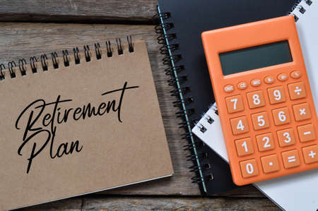 Top view of notebook written with text RETIREMENT PLAN.の写真素材