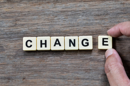 Top view of scrabble letters with text CHANGE over wooden background.の写真素材