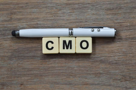 Pen and square letters with text CMO stands for CHIEF MARKETING OFFICERの写真素材