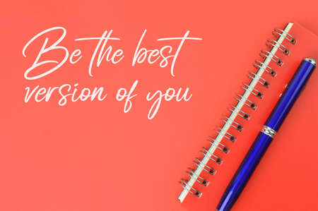 Pen and notebook over red background written with BE THE BEST VERSION OF YOU.の写真素材