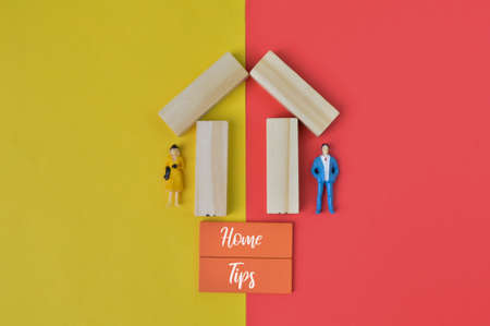 people miniatures and house building blocks written with HOME TIPS.の写真素材