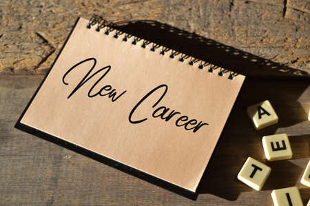 Alphabet letters and notebook written with NEW CAREER. Business and education concept.
